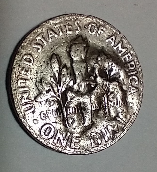 Looking-For-Thoughts-On-The-Curious-Surface-On-This-1966-Roosevelt-Dime